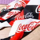 Mbajtese Flokesh Coca Cola